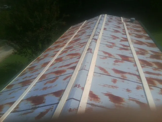Rusted metal roof panels with new wood purlins before replacement — Storm Damage Roof Repair in Ringoes by Roofing Brothers