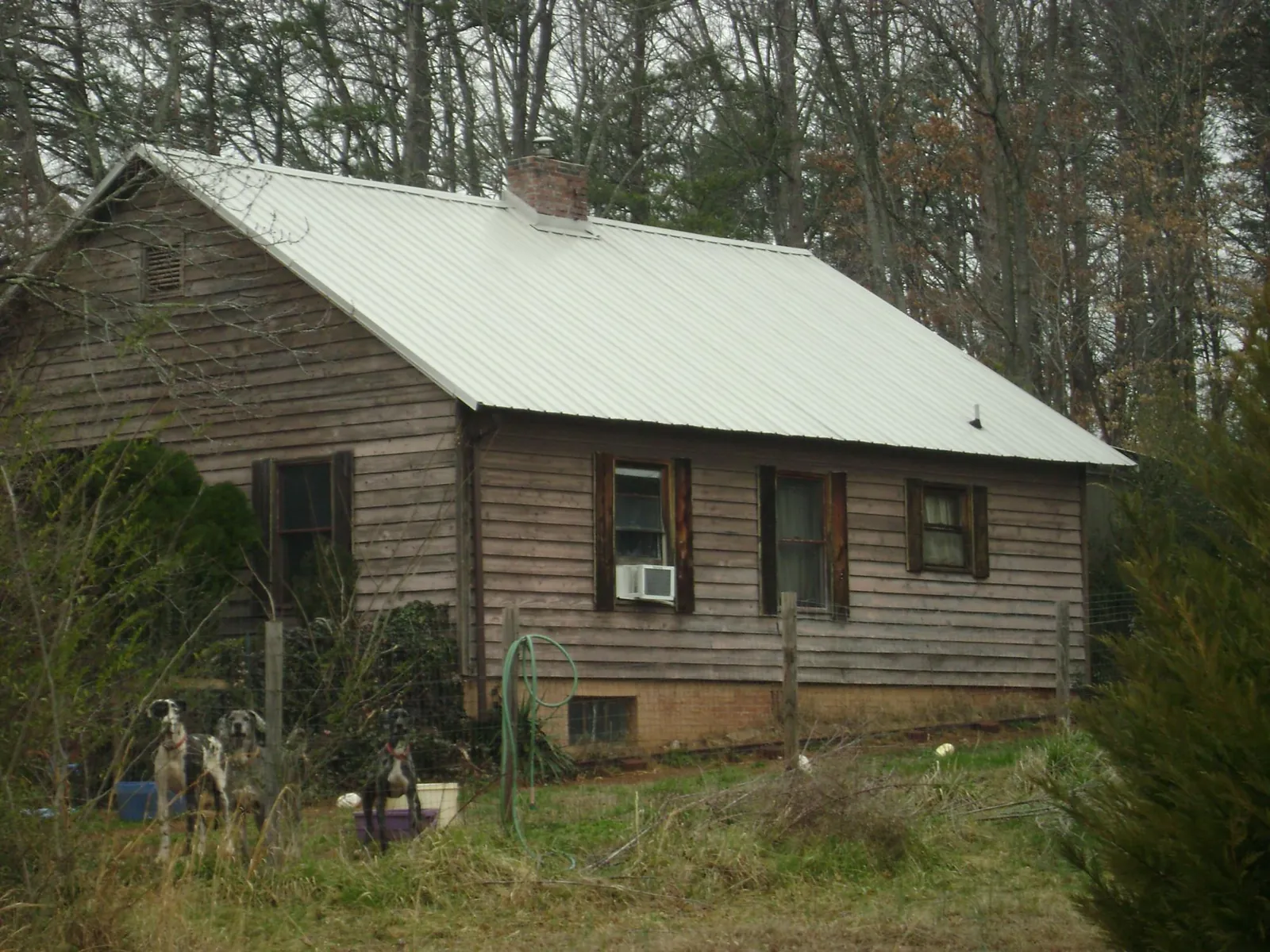 White metal roof on an old wood sided farmhouse, from a Metal Roof Installation job in Ringoes